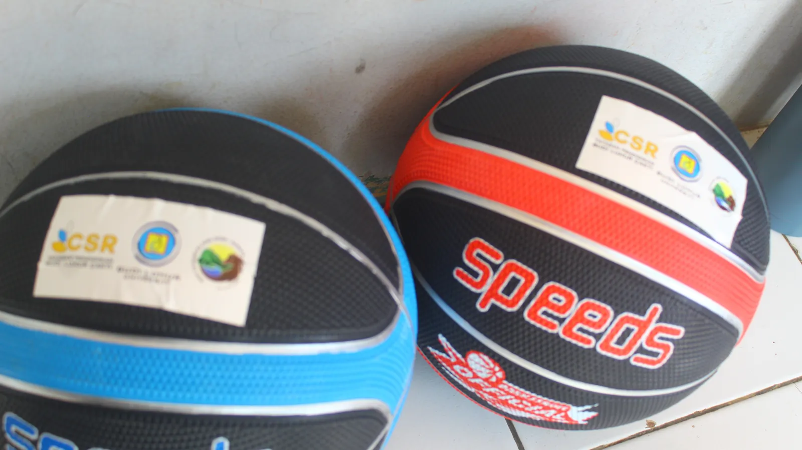 Dua bola basket berwarna hitam-biru dan hitam-merah berlabel CSR.