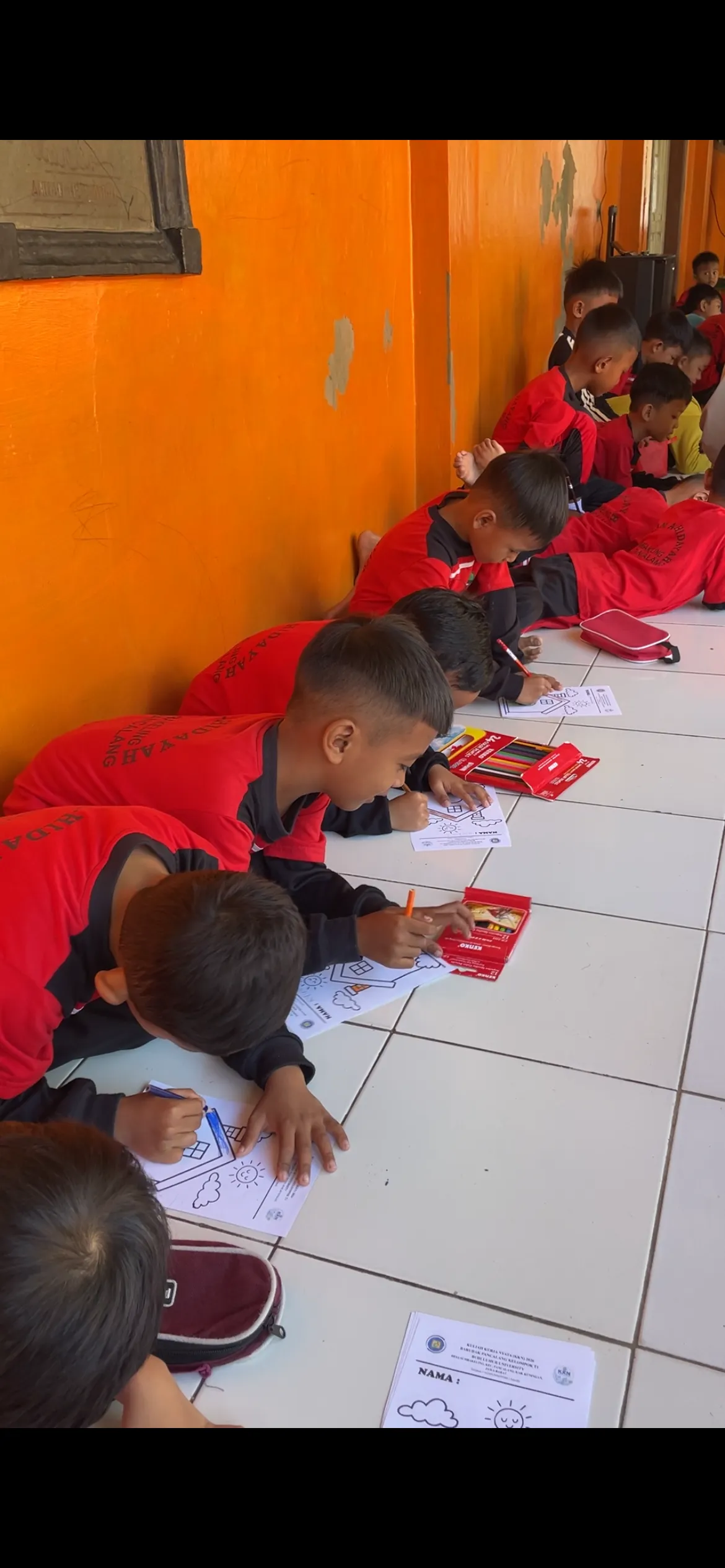 Peserta didik TK Al-Hidayah mewarnai lembar aktivitas dengan pensil warna.